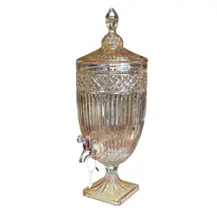 Foto de um(a) Suqueira Dispensador de Bebidas em Vidro Âmbar Canelado com Torneira e Tampa, da categoria de Garrafas, potes e jarros. Adicione um toque de elegância clássica e sofisticação aos seus eventos ou à decoração da sua casa com esta magnífica peça... Vendido no marketplace Trésors.