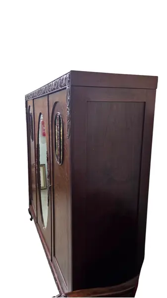 Foto de um(a) Guarda Roupa 3 Portas, Imbuia Maciça entalhado a mão, da categoria de Armários e Guarda Roupas. Guarda roupa 3 portas em imbuia maciça entalhado a mão, com espelho bisotê!. Mostrado de uma perspectiva diferente. Vendido no marketplace Trésors.