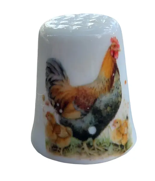 Foto de um(a) Dedal de Coleção em Porcelana – Galo e Pintinhos, da categoria de Outros colecionáveis. Este encantador dedal em porcelana apresenta uma cena bucólica clássica, retratando a vida no campo. Com uma ilustração... Mostrado de uma perspectiva diferente. Vendido no marketplace Trésors.